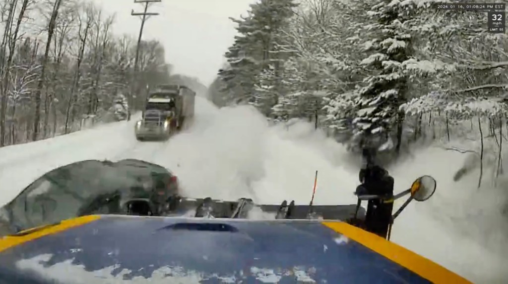 The passenger car tried to speed up and overtake the semi-truck, but couldn't gain enough pickup in road covered in slush and snow. 