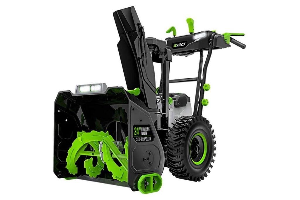 A large snow blower in green and black.