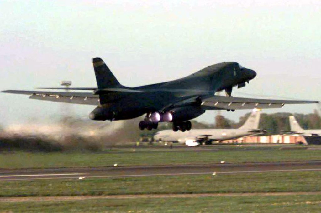 Air Force bomber takes off from a runway.