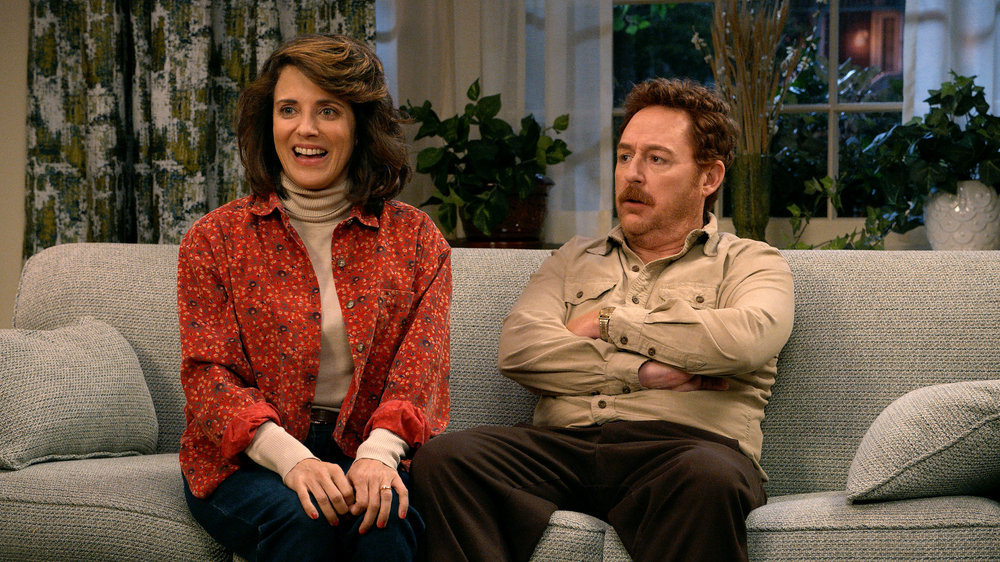 Alann Ubach and Scott Grimes as John's parents, Matty and Susan.