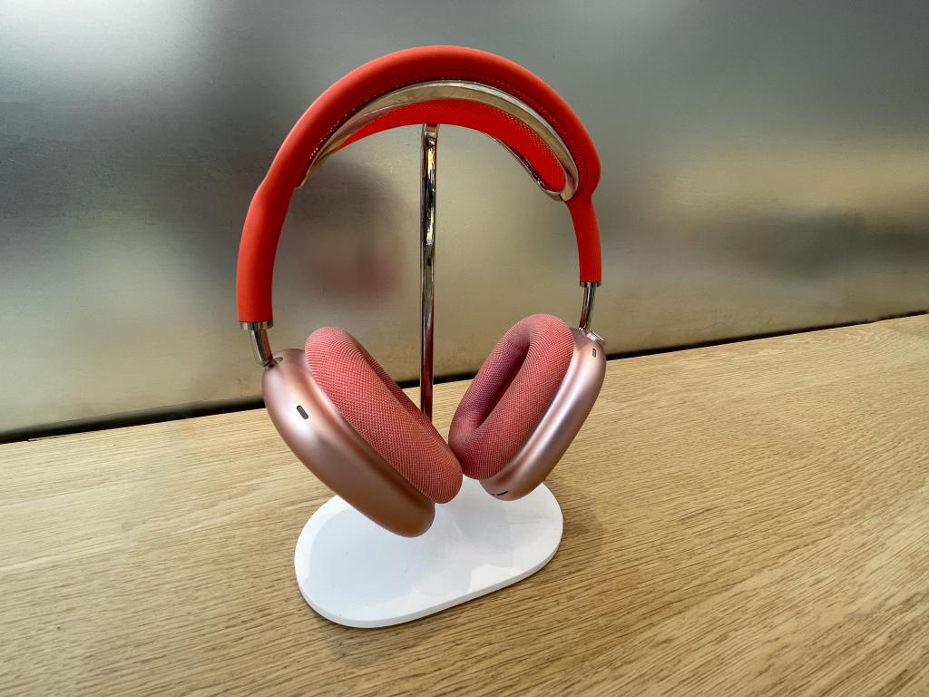 AirPod Max headphones in red displayed on counter