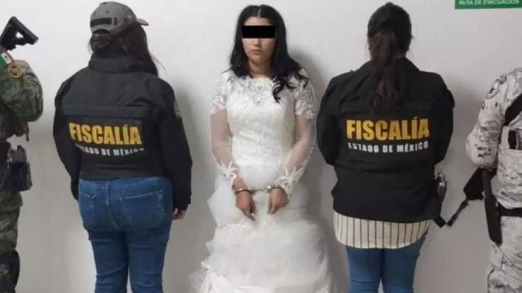 Busted bride seen in wedding dress and handcuffs