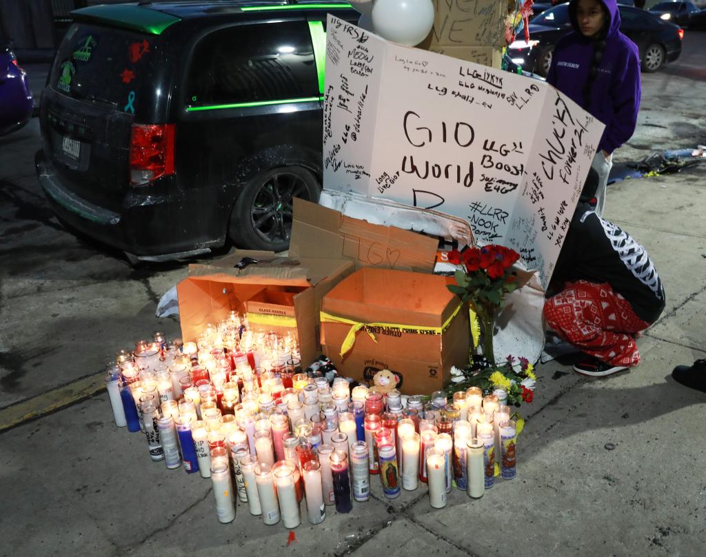 A candle memorial with a large police presence checking the vehicles and documents of drivers, at a rally, gathering of possible supporters, friends of the victim that died while doing donuts this morning in the Bronx, at Viele Av and Bryant Av.