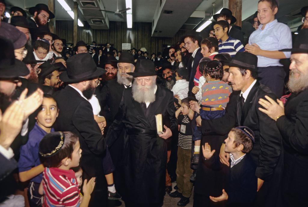 Lubavitcher Rebbe Menachem Mendel Schneerson walking through a crowd of devotees