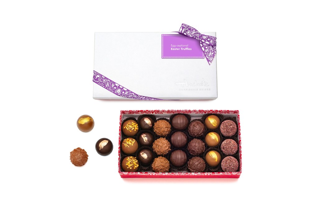 A box of chocolates with a purple bow.