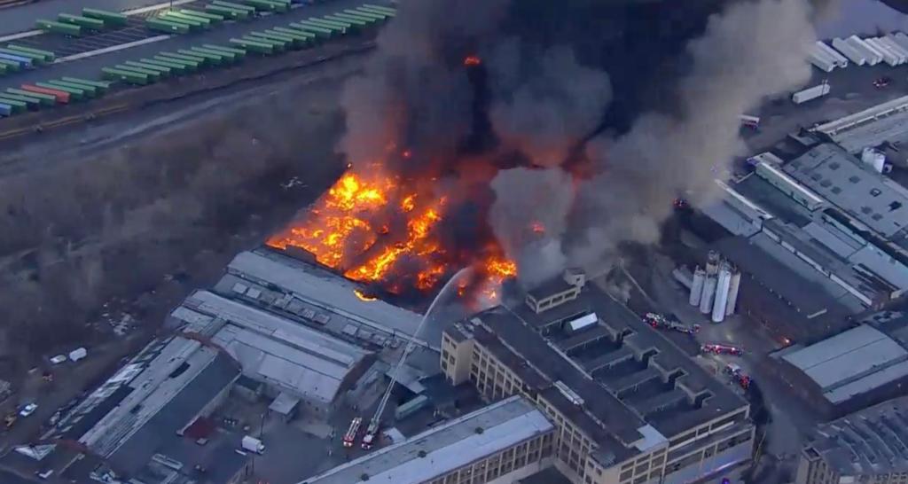 A massive fire seen burning through a warehouse in Elizabeth, New Jersey, Friday