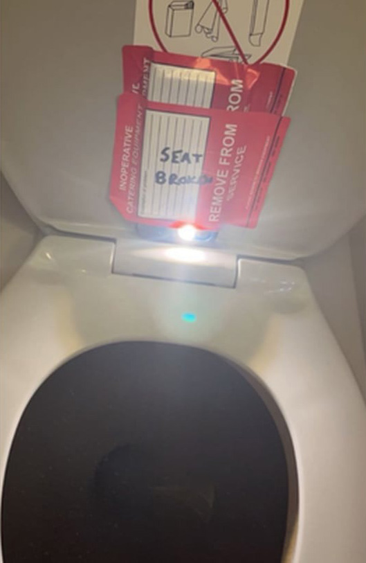 hidden camera taped to toilet seat with red sticker