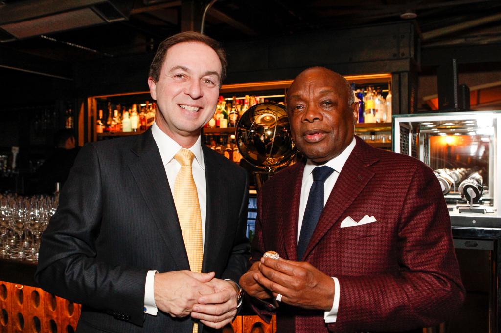 A photo of Golden State Warriors owner Joe Lacob and Willie Brown with a bar and glasses behind them.