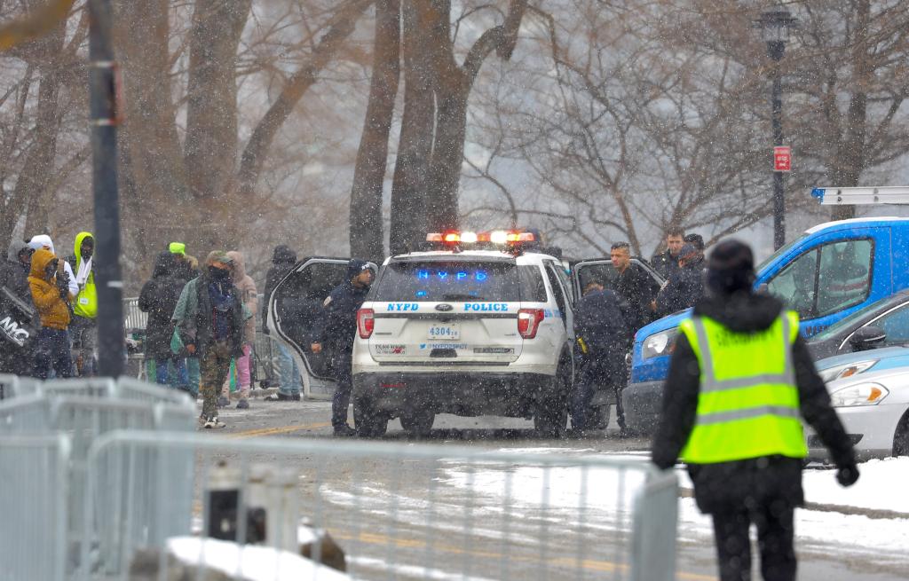 Police load a suspect into an NYPD SUV.