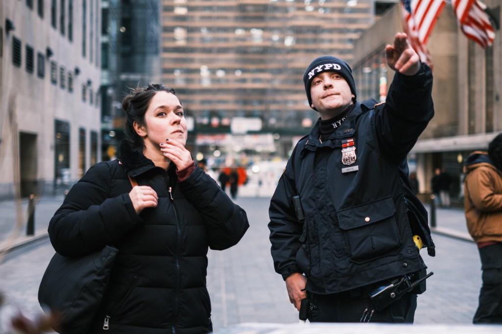 A NYPD officer gives directions in Rockefeller Center. 