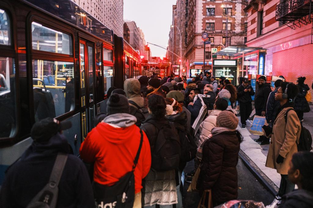 People board a bus after being evacuated from a train further south of the crash.