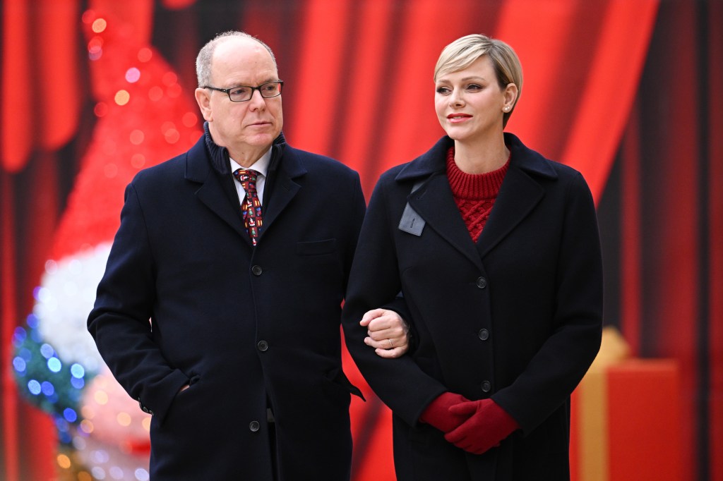 Prince Albert and Princess Charlene walking with their arms entwined.