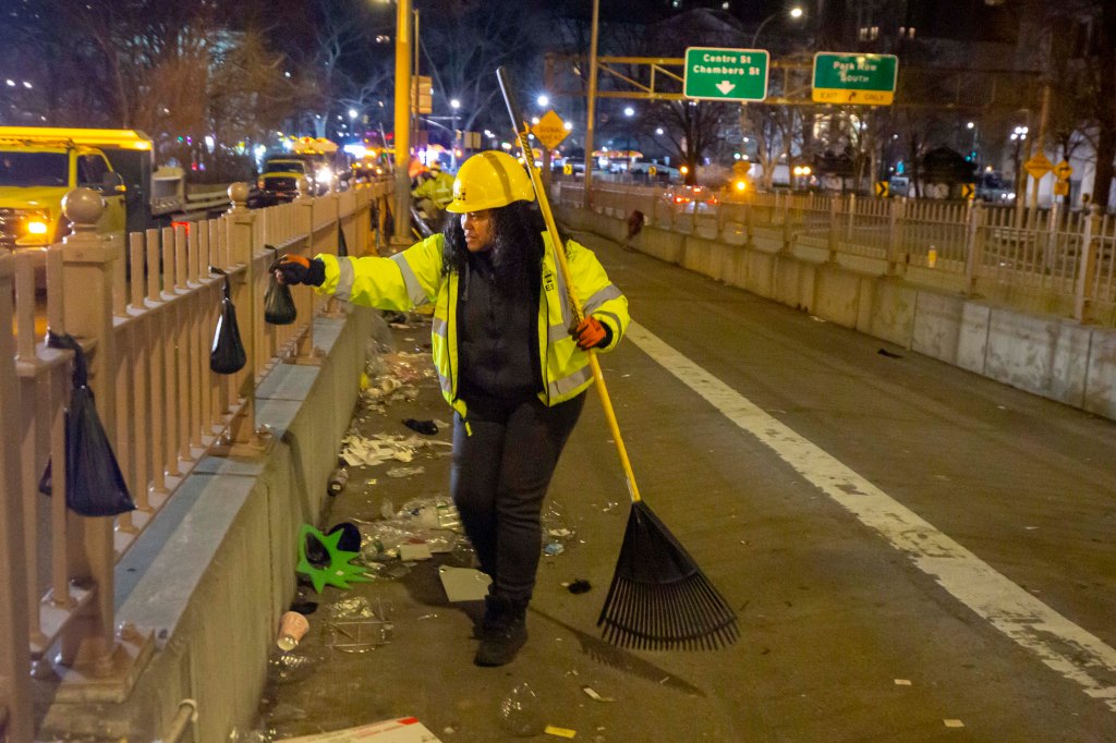 City workers clear the Brooklyn Bridge. 