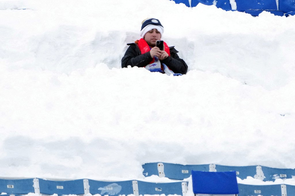 A Buffalo Bills fan sits in the snow during the 2024 AFC wild card game against the Pittsburgh Steelers at Highmark Stadium on Jan. 15, 2024.