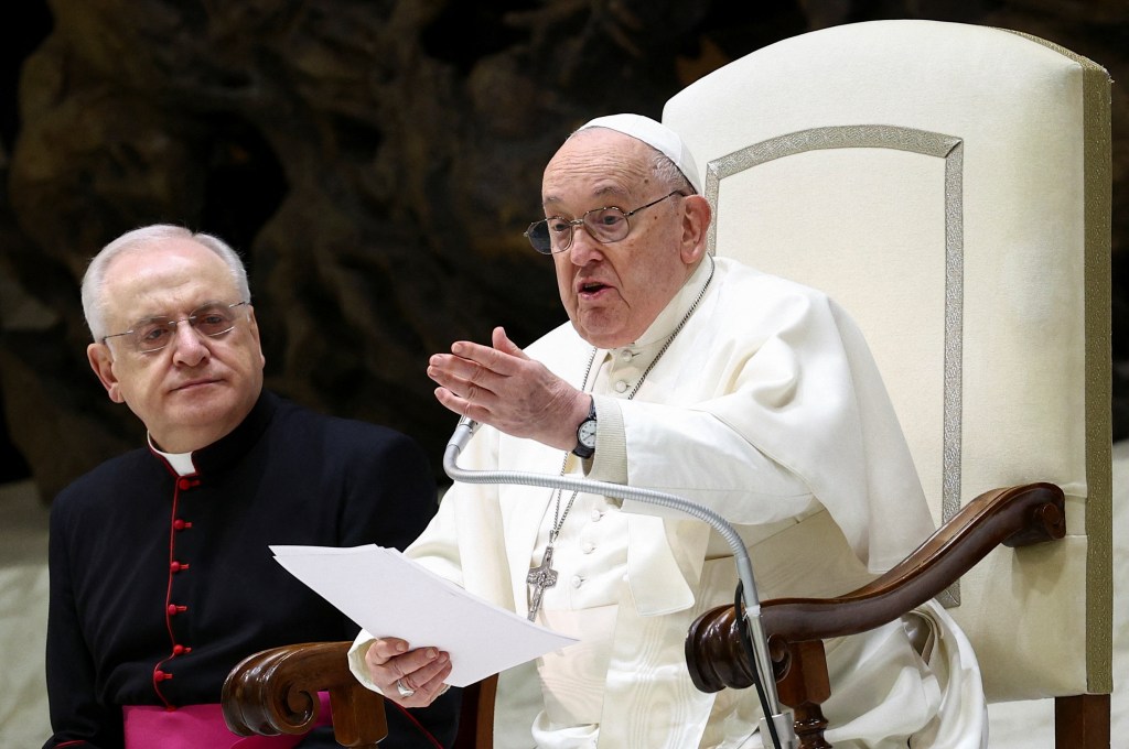 Pope Francis sitting in a chair. 