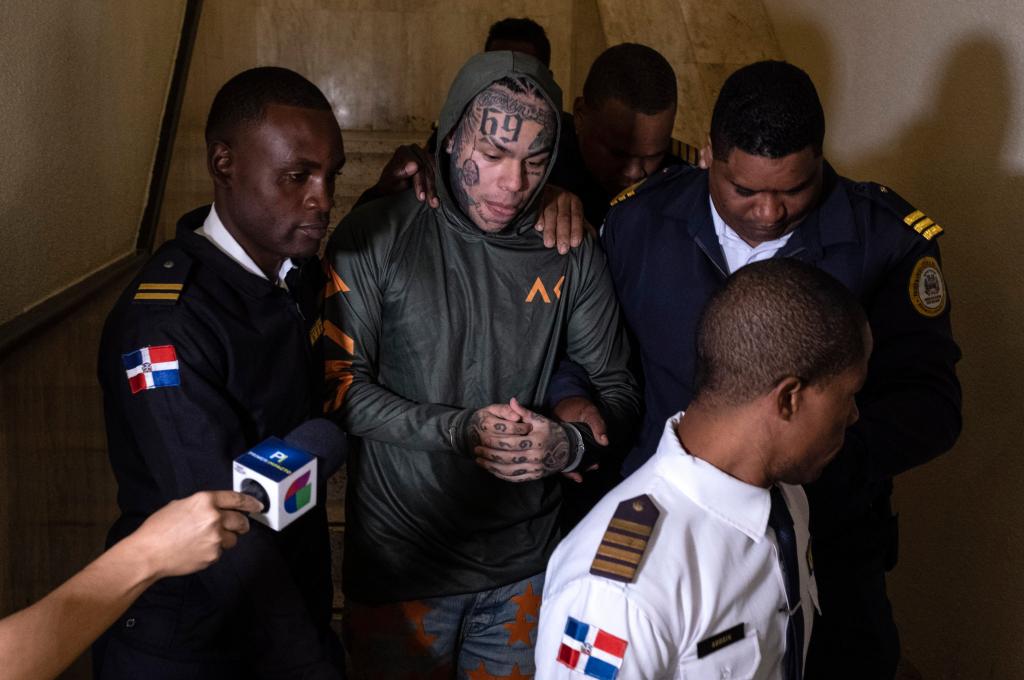 Tekashi 6ix9ine escorted by police outside Palace of Justice in Santo Domingo, Dominican Republic, after domestic violence arrest.