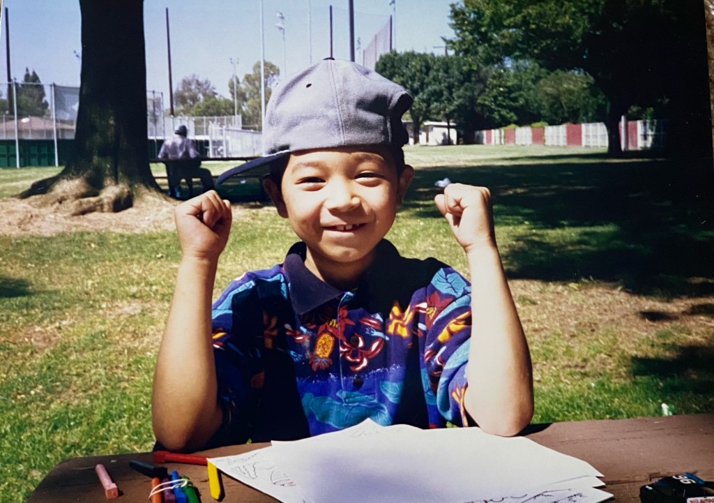 Rob Henderson as a child wearing sideways cap.