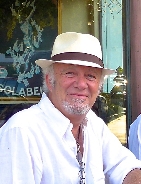 A photo of Robert Eringer smiling while wearing a white hat.