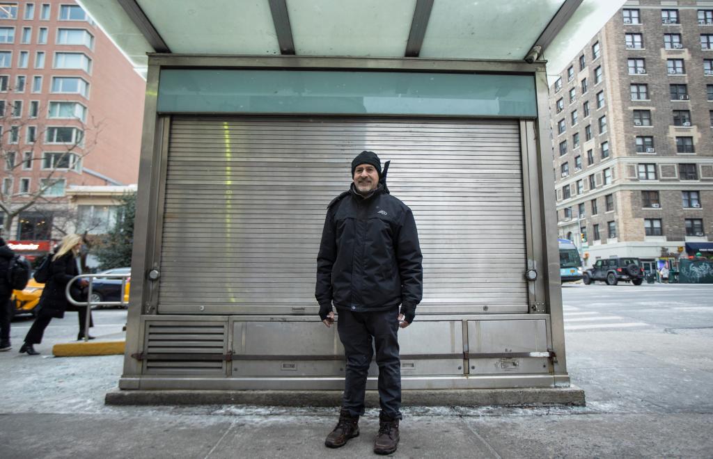 Sadik Topia standing outside of his shuttered newsstand in the Upper West Side