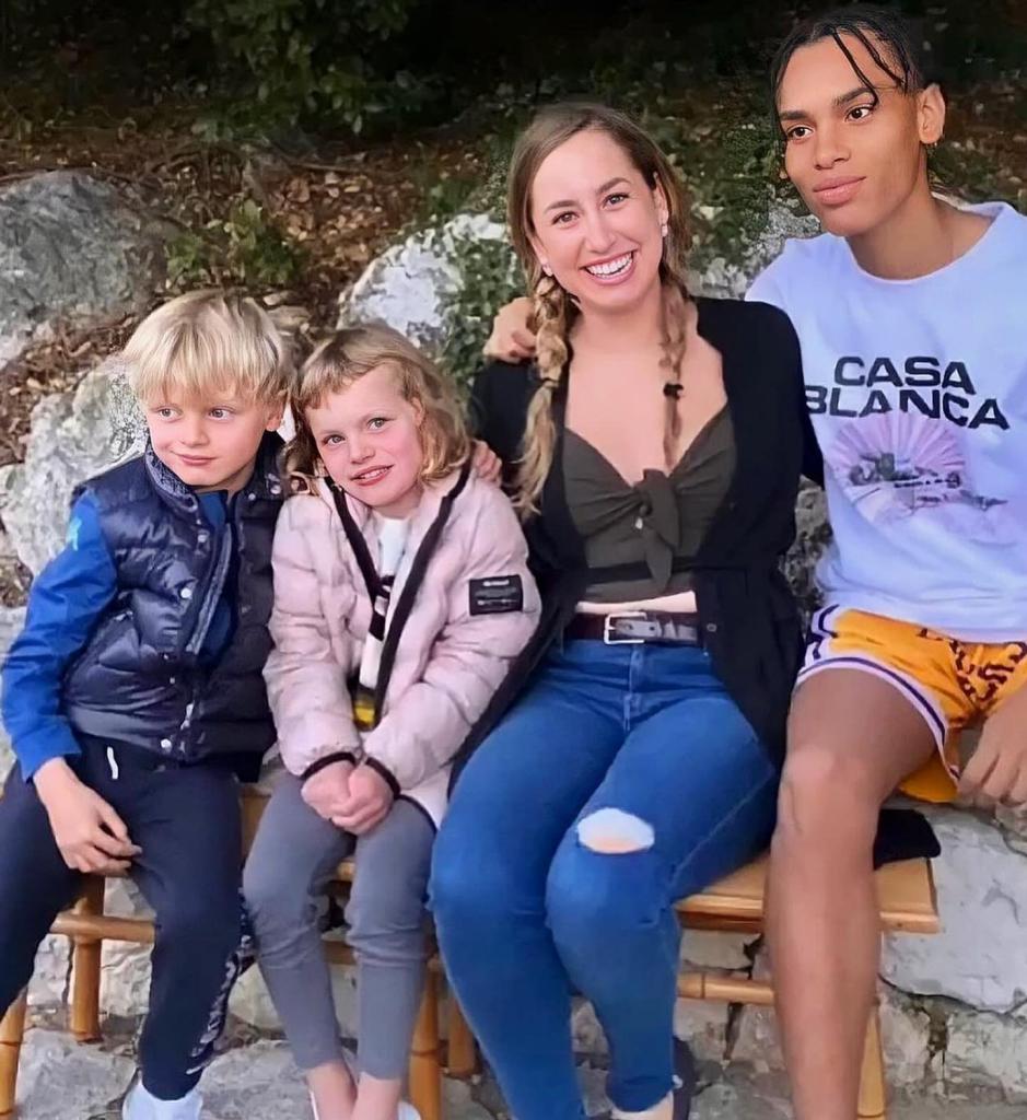 Prince Jacques of Monaco, Princess Gabriella of Monaco, Jazmin Grimaldi and Alexandre Grimaldi-Coste sitting outside on a bench.