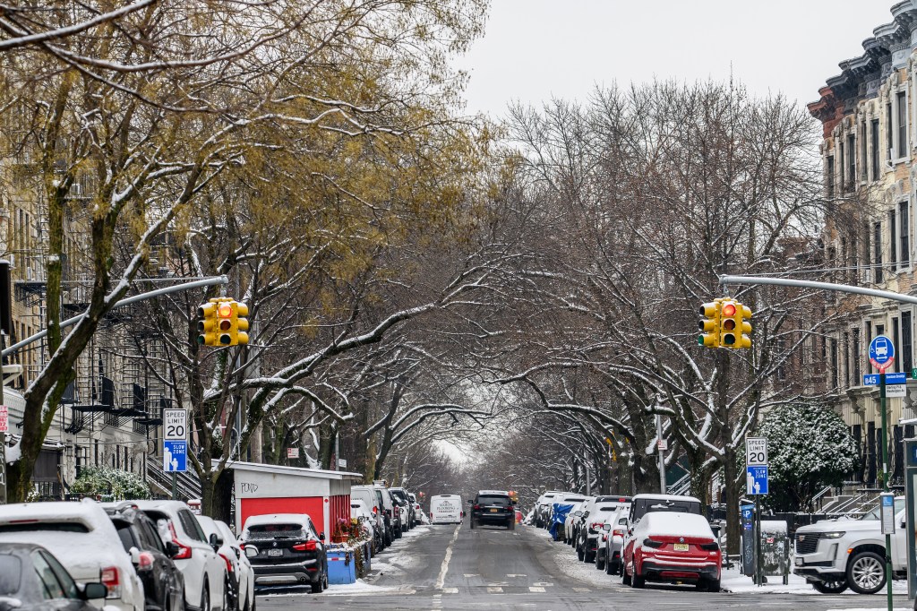 : A view down Sterling Pl. in the Crown Heights Neighborhood of Brooklyn covered in snow.