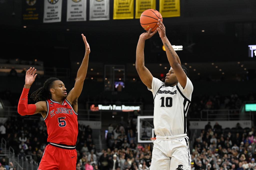 Friars forward Rich Barron (10) shoots the ball over St. John's Red Storm guard Daniss Jenkins