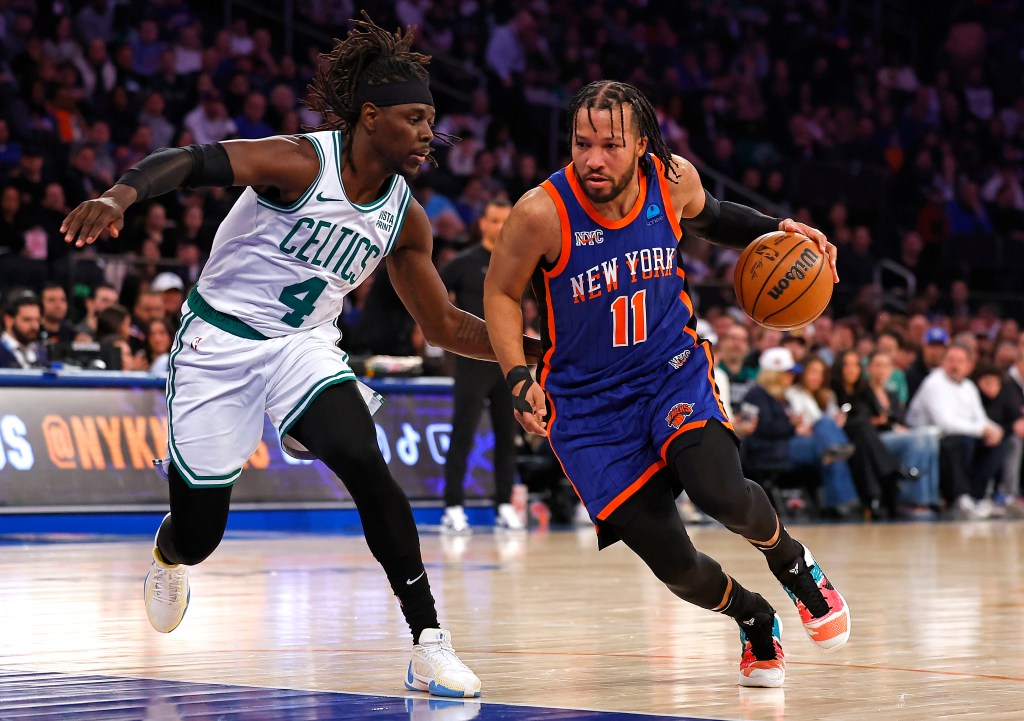 Jalen Brunson drives to the basket as Jrue Holiday gives chase during the first half at Madison Square Garden.