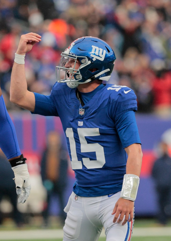 New York Giants quarterback Tommy DeVito #15 celebrates after throwing a touchdown pass in the 2nd quarter against the New England Patriots.