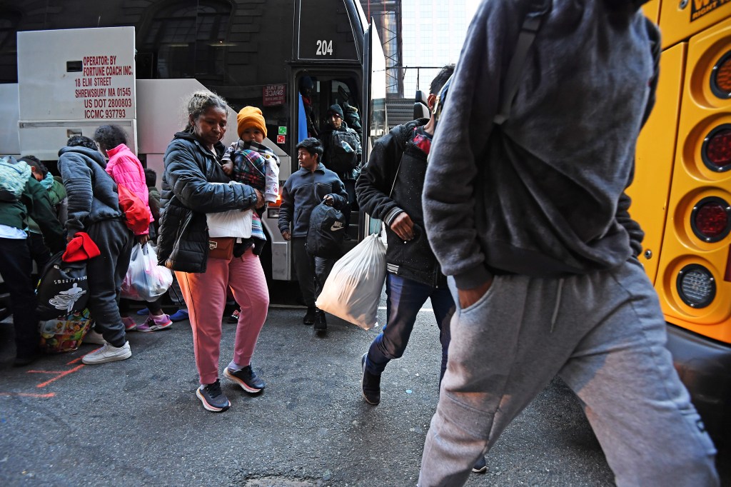 A new bus load of migrants arrive at the Roosevelt Hotel