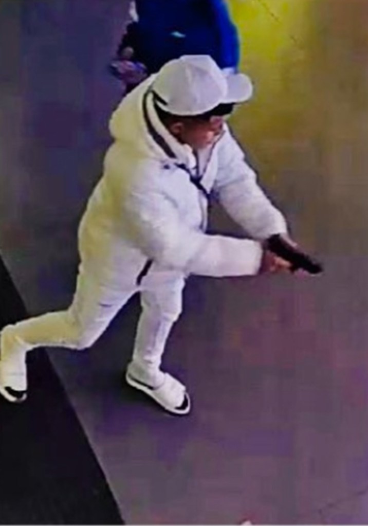 Suspect on video holding a gun