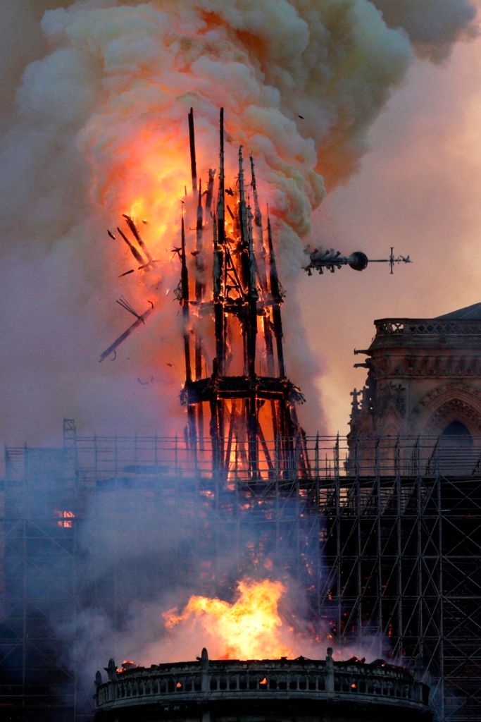 The steeple collapses as smoke and flames engulf the Notre-Dame Cathedral in Paris on April 15, 2019.