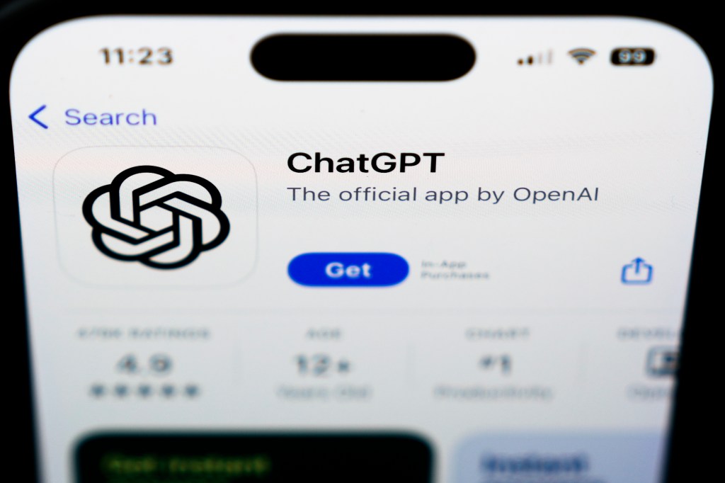 A ChapGPT logo seen on a smartphone screen displaying a news article stating false & misleading AI information is the top immediate risk to the global economy