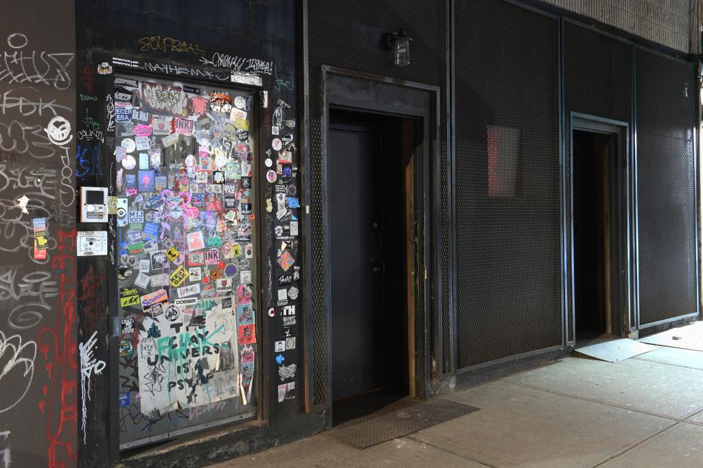 Exterior with sticker-covered door of Saint Vitus Bar