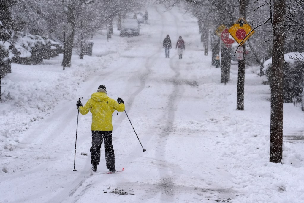 A man uses cross-country skis to move on a residential street in Providence, R.I. on Feb. 13, 2024.