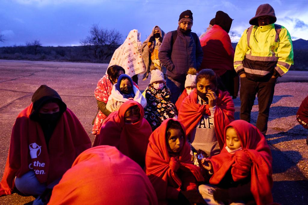 Migrants gather to be processed and transported outside a  U.S. Customs and Border Protection station 