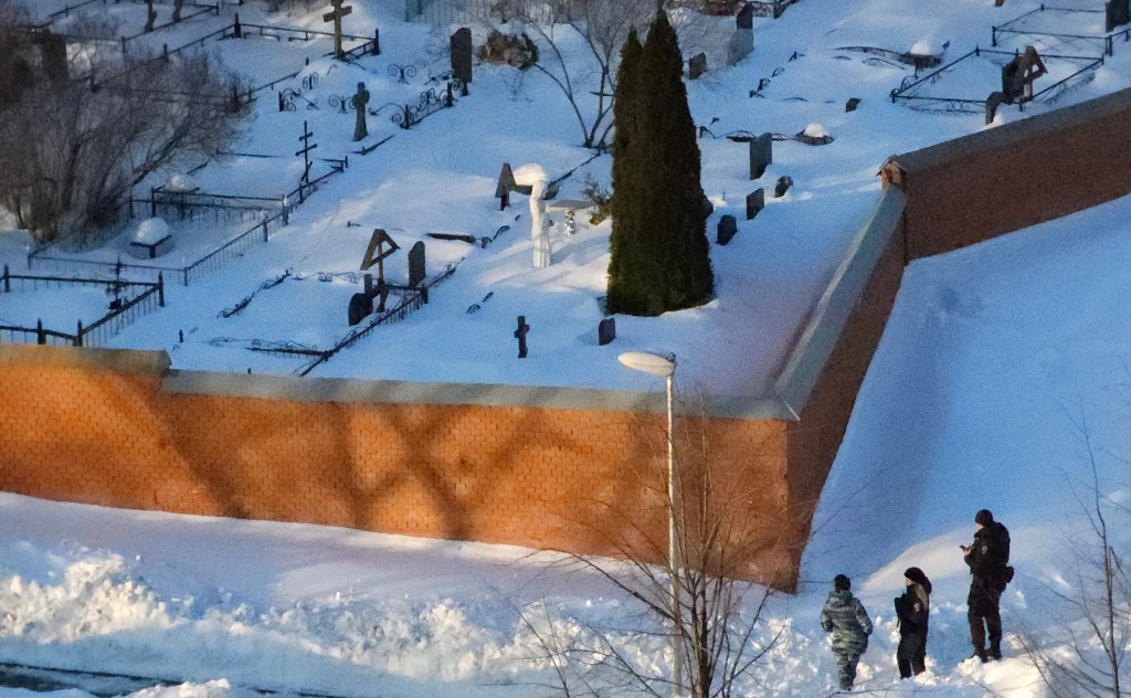 Russian Police officers guard the area near the fence of the Borisov cemetery where Alexey Navalny is expected to be buried this week, on February 27, 2024 in Moscow, Russia. 