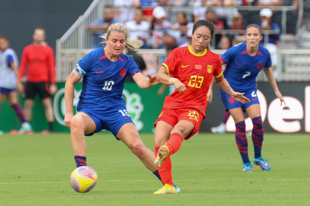 Lindsey Horan fights for the ball with China's midfielder #23 Jiali Tang during the women's international friendly football match.