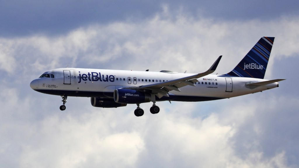 A file photo of a JetBlue plane in the sky.