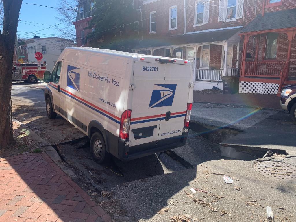 mail truck in sink hole