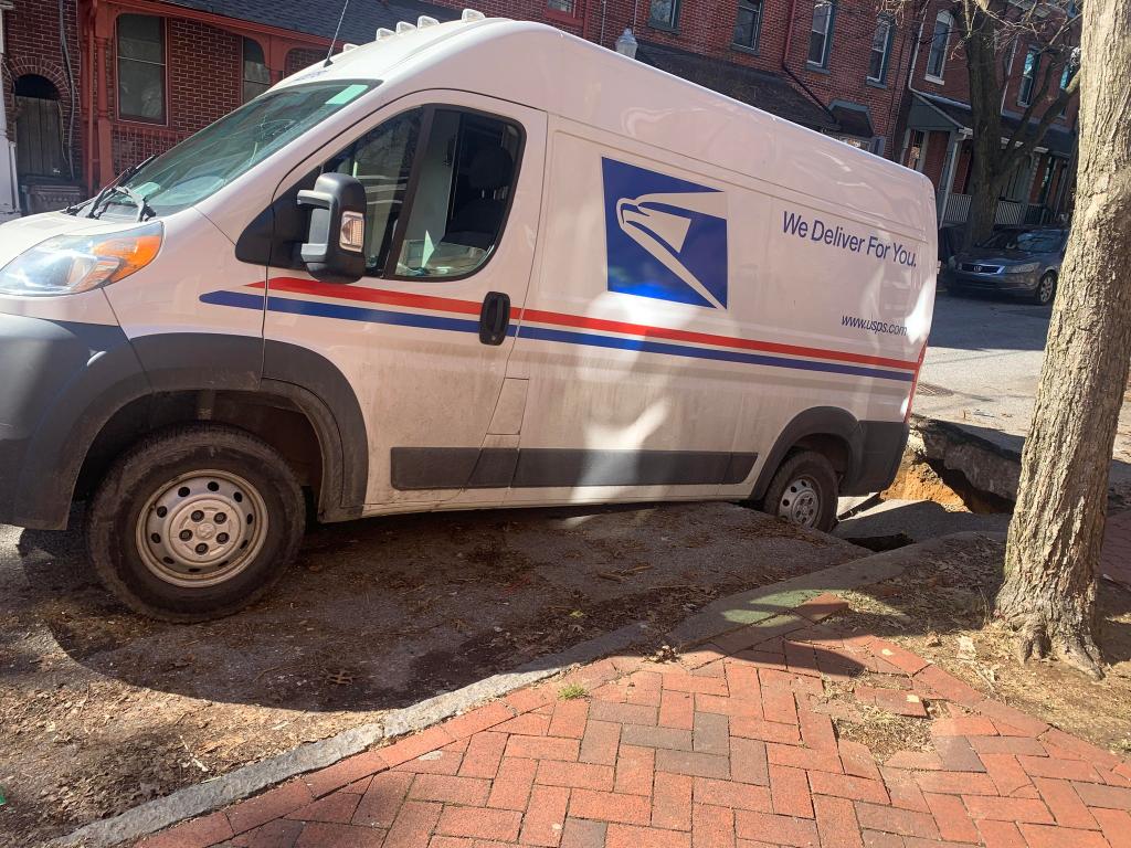 mail truck in sinkhole