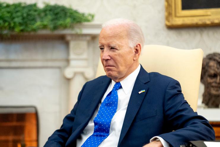 President Joe Biden sits in the Oval Office with German Chancellor Olaf Scholz.