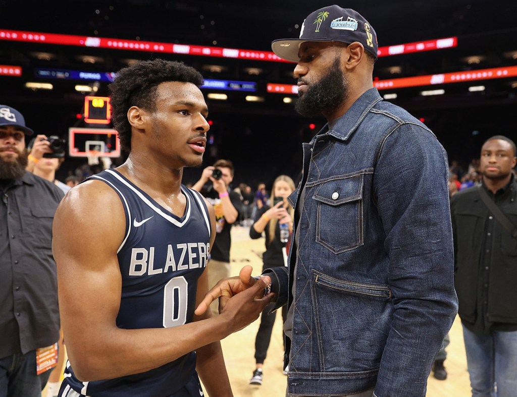 Bronny James #0 of the Sierra Canyon Trailblazers is greeted by his father and NBA superstar LeBron James after defeating the the Perry Pumas in the Hoophall West tournament at Footprint Center on December 11, 2021 in Phoenix, Arizona.  