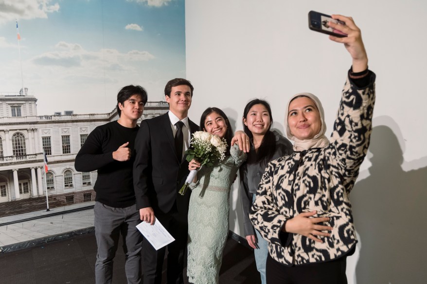 Parviz and Vasila taking a photo with family members after the wedding.