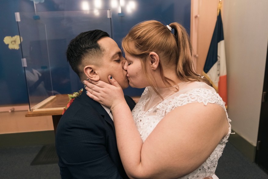 Juan Carlos Calderon Andrade sharing a kiss after getting married.