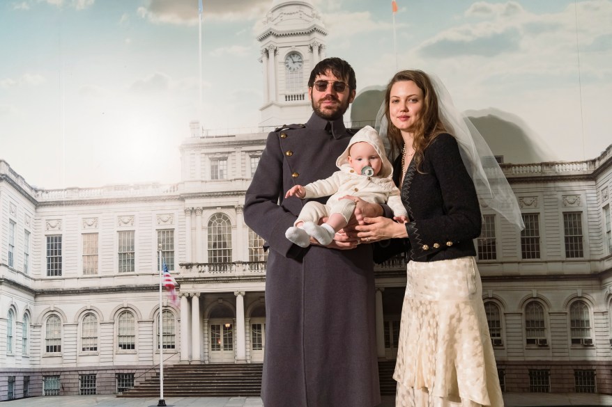 Brion and Lindsey taking a photo with their baby after the ceremony.