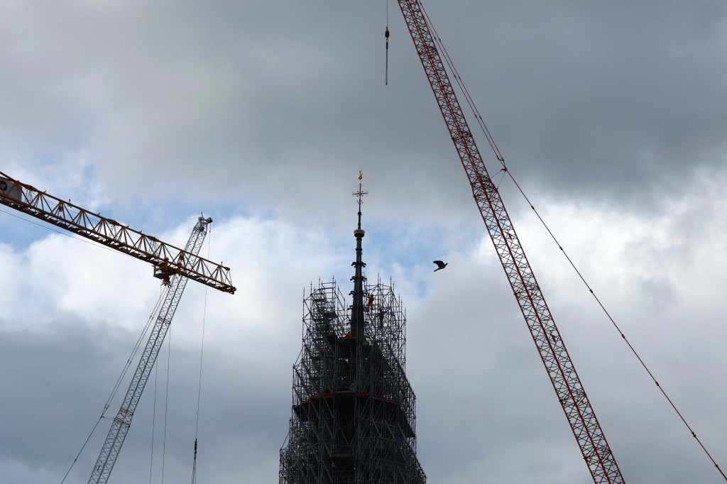 Scaffolding is being removed around the spire of Notre Dame de Paris cathedral, showing the rooster and the cross, on Feb. 12, 2024 in Paris. 