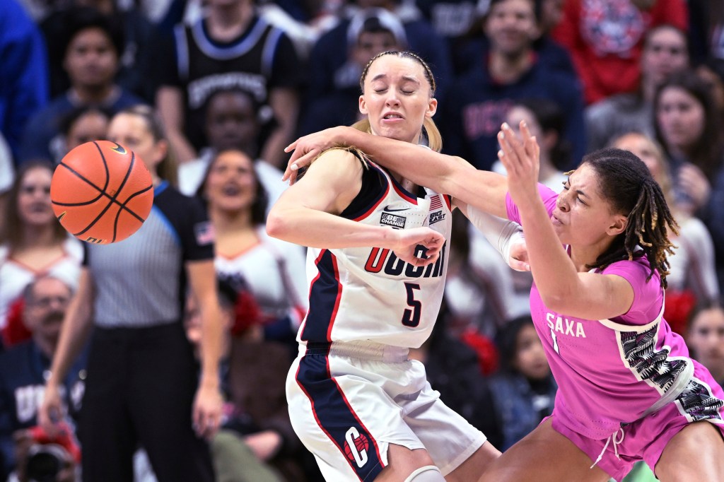 UConn guard Paige Bueckers (5) takes it on the chin while defending against Georgetown guard Kelsey Ransom (1)  during the second half 