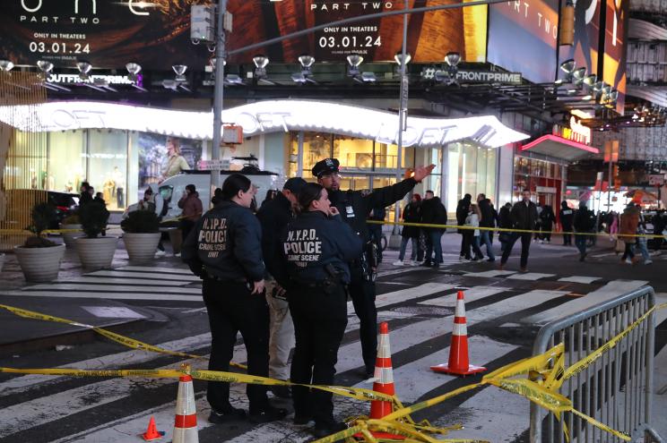 Police activity at the scene where a woman was shot inside a store in Times Square, Manhattan with group of police officers on site.