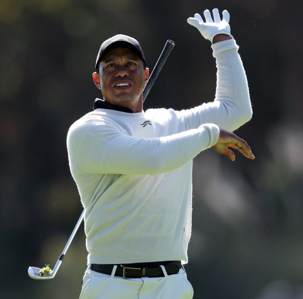 Tiger Woods drops his club after hitting a shank on the 18th hole during the first round of the Genesis Invitational.