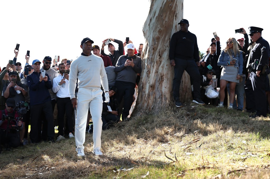 Tiger Woods surveys his third shot from the rough on the 18th hole after a second-shot shank during the first round of the Genesis Invitational.